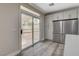 Bright kitchen features stainless steel appliances, gray wood floors, and sliding glass doors to the backyard at 8605 Wild Diamond Ave, Las Vegas, NV 89143