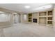 Spacious living room featuring a cozy fireplace and custom built-in shelving at 8605 Wild Diamond Ave, Las Vegas, NV 89143