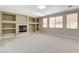 Bright living room with custom built-ins surrounding the fireplace and large windows at 8605 Wild Diamond Ave, Las Vegas, NV 89143