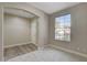 Living room featuring a large window letting in natural light, neutral walls, and a plush carpeting at 8605 Wild Diamond Ave, Las Vegas, NV 89143