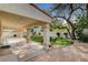 Covered patio offers a relaxed outdoor space with tiled floors and views of the landscaped backyard at 8605 Wild Diamond Ave, Las Vegas, NV 89143