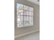 Bedroom featuring a large window letting in natural light, neutral walls, and plush carpeting at 8605 Wild Diamond Ave, Las Vegas, NV 89143