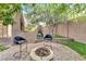 Outdoor fireplace and seating, surrounded by landscaping and privacy wall at 8629 Estrelita Dr, Las Vegas, NV 89128