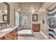 Detailed bathroom with a walk-in glass shower, dual sink vanity, and bamboo curtain at 8629 Estrelita Dr, Las Vegas, NV 89128