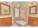 Bathroom featuring dual vanities and a glass-enclosed shower with tile accents at 8629 Estrelita Dr, Las Vegas, NV 89128