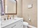 Elegant half bathroom featuring modern sink, framed mirror, and decorative artwork at 8629 Estrelita Dr, Las Vegas, NV 89128