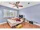 Calm bedroom featuring a ceiling fan, wood floors, and a window with plantation shutters at 8629 Estrelita Dr, Las Vegas, NV 89128