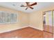 Bedroom with hardwood floors, ceiling fan, and shuttered windows at 8629 Estrelita Dr, Las Vegas, NV 89128