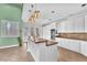 Bright eat-in kitchen featuring a center island, white cabinetry, stainless appliances, and charming breakfast bar at 8629 Estrelita Dr, Las Vegas, NV 89128