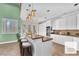 Bright eat-in kitchen featuring a center island, white cabinetry, stainless appliances, and charming breakfast bar at 8629 Estrelita Dr, Las Vegas, NV 89128
