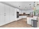 Bright open-concept kitchen boasts white cabinets, stainless appliances, and center island at 8629 Estrelita Dr, Las Vegas, NV 89128
