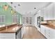 Bright eat-in kitchen featuring a center island, white cabinetry, stainless appliances, and updated fixtures at 8629 Estrelita Dr, Las Vegas, NV 89128