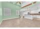 Spacious open-concept living room and kitchen with neutral color palette and vaulted ceiling at 8629 Estrelita Dr, Las Vegas, NV 89128