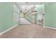 Spacious living room with tile floors, staircase, and large windows at 8629 Estrelita Dr, Las Vegas, NV 89128