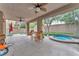 Covered patio with outdoor seating area, ceiling fans and a hot tub at 8629 Estrelita Dr, Las Vegas, NV 89128