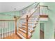 Bright staircase with wooden steps and white railings leading to the upper level at 8629 Estrelita Dr, Las Vegas, NV 89128