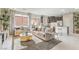 Bright and airy living room featuring a large window, neutral tones, a plush rug, and modern furnishings at 8917 Pebble Sand St, Las Vegas, NV 89178