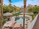 Aerial view of the backyard showcasing the custom pool, tiki hut, and lush landscaping at 8970 Lansberry Ct, Las Vegas, NV 89147