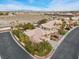 Aerial view of a beautiful home featuring a backyard with a custom pool and tiki hut at 8970 Lansberry Ct, Las Vegas, NV 89147