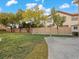 Expansive backyard featuring lush green grass, mature trees, and a well-maintained fence for privacy at 8970 Lansberry Ct, Las Vegas, NV 89147