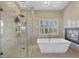 A luxurious bathroom with a spacious shower and soaking tub that offers a relaxing retreat at 8970 Lansberry Ct, Las Vegas, NV 89147