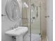 Bathroom features a pedestal sink, a walk-in shower with glass door and tile surround at 8970 Lansberry Ct, Las Vegas, NV 89147