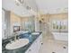 Bathroom featuring a soaking tub, and fireplace, exuding elegance and relaxation at 8970 Lansberry Ct, Las Vegas, NV 89147