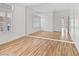 Sunlit bedroom has hardwood floors, neutral paint, and a closet with mirror doors at 8970 Lansberry Ct, Las Vegas, NV 89147