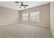 Spacious bedroom with large windows and neutral carpet at 8970 Lansberry Ct, Las Vegas, NV 89147