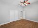 This bedroom features hardwood floors, a ceiling fan, and a closet at 8970 Lansberry Ct, Las Vegas, NV 89147