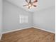 Spacious bedroom with ceiling fan and a large window with privacy shutters at 8970 Lansberry Ct, Las Vegas, NV 89147