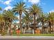 Inviting community entrance with lush palm trees and decorative accents at 8970 Lansberry Ct, Las Vegas, NV 89147