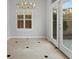 Bright dining area with tile floors, a window with shutters, and access to the patio at 8970 Lansberry Ct, Las Vegas, NV 89147