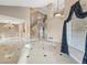 Spacious living room highlighting a staircase, high ceilings, tiled floors, and elegant chandelier at 8970 Lansberry Ct, Las Vegas, NV 89147