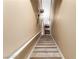 Carpeted staircase with white railings, ascending to the upper level, featuring classic decorative lighting fixtures at 9000 Las Vegas Blvd # 2243, Las Vegas, NV 89123