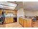 A kitchen with a dining bar features modern appliances and a seamless transition to the living room at 905 Rockview Dr # 101, Las Vegas, NV 89128