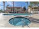 A hot tub and pool are surrounded by a fence with apartment buildings in the background at 905 Rockview Dr # 101, Las Vegas, NV 89128