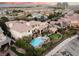 Aerial view of a stunning backyard with a pool, spa, putting green, and outdoor living area at 9325 Verlaine Ct, Las Vegas, NV 89145