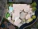 Aerial view of the property showcasing a large home, pool, putting green and landscaped grounds at 9325 Verlaine Ct, Las Vegas, NV 89145