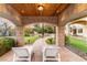 Beautiful backyard featuring a stone patio with lounge chairs, putting green, and lush landscaping at 9325 Verlaine Ct, Las Vegas, NV 89145