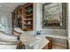 Home bar area featuring granite countertops, display shelving, and wood cabinetry at 9325 Verlaine Ct, Las Vegas, NV 89145