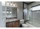 Bathroom featuring granite countertop vanity and shower/tub combination with stylish marble tile surround at 9325 Verlaine Ct, Las Vegas, NV 89145