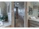 Luxurious bathroom featuring a frameless shower with multiple shower heads at 9325 Verlaine Ct, Las Vegas, NV 89145