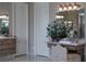 Elegant bathroom with stylish vanity, dual sinks, and ornate mirror, complemented by two panelled doors at 9325 Verlaine Ct, Las Vegas, NV 89145