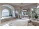 Luxurious bathroom featuring a soaking tub, walk-in shower, dual sinks, and stylish vanity at 9325 Verlaine Ct, Las Vegas, NV 89145