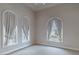 Sunlit bedroom featuring arched windows with elegant, neutral curtains at 9325 Verlaine Ct, Las Vegas, NV 89145