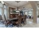 Formal dining room featuring decorative curtains, a large display cabinet, and a view into the living area at 9325 Verlaine Ct, Las Vegas, NV 89145