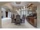 Formal dining room featuring a large table, upholstered chairs, and elegant chandelier at 9325 Verlaine Ct, Las Vegas, NV 89145