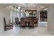 Formal dining room with travertine floors, beautiful chandelier, and traditional-style furnishings at 9325 Verlaine Ct, Las Vegas, NV 89145