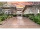 Long, patterned concrete driveway leading to a luxury home with manicured landscaping and arched entryway at 9325 Verlaine Ct, Las Vegas, NV 89145